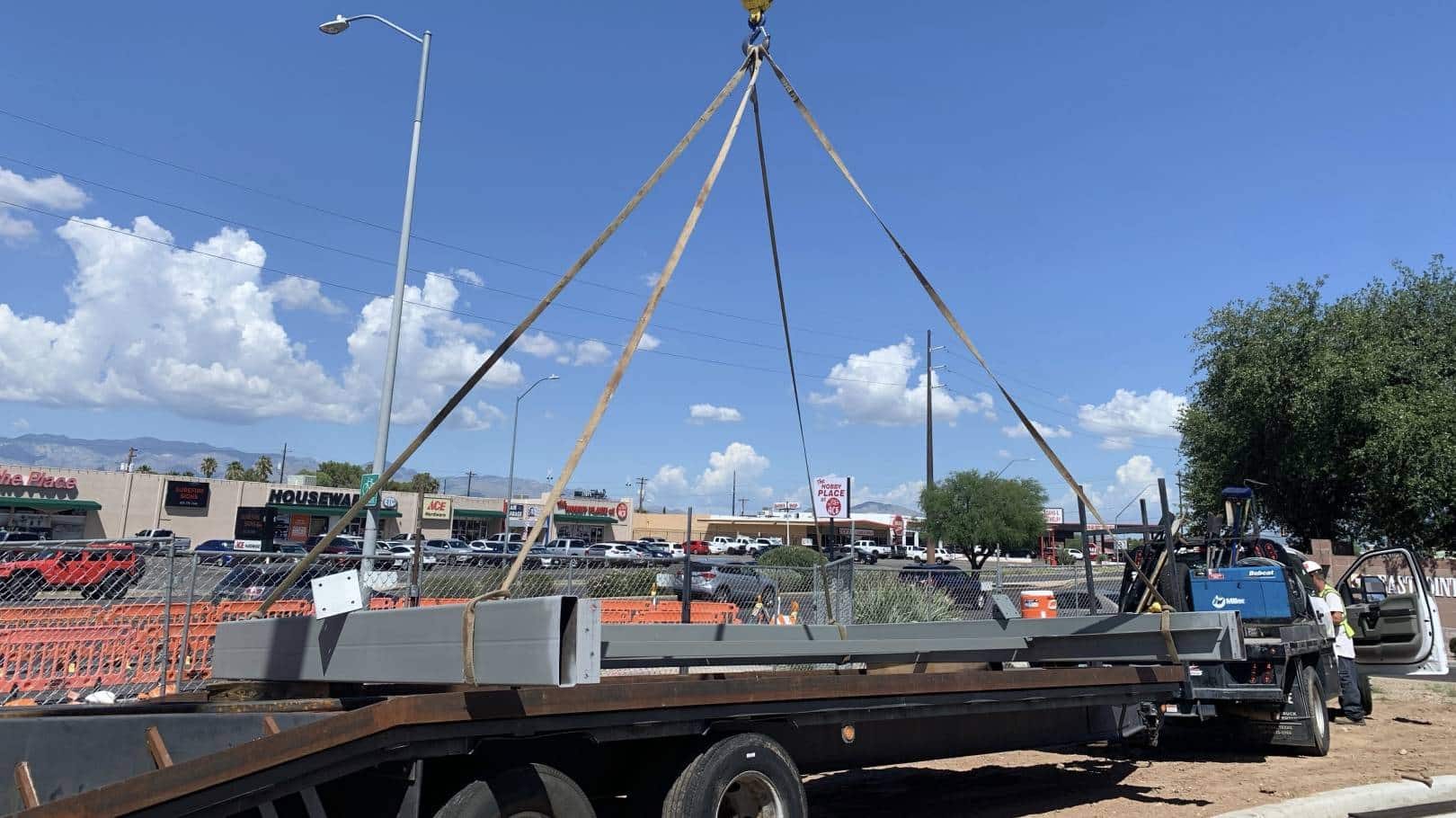 Steel beams being lifted for construction