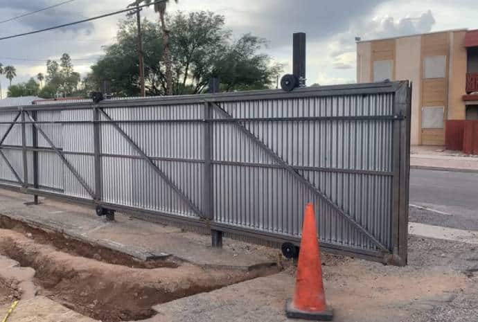 Metal gate with construction area visible