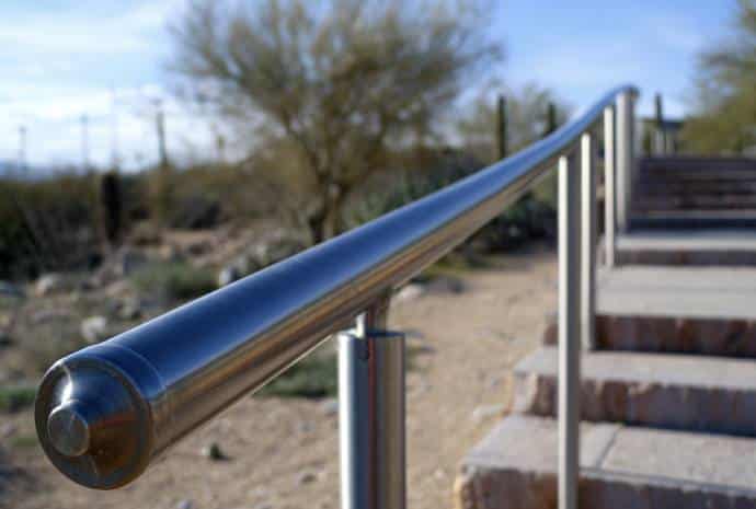 Shiny metal handrail beside stairs