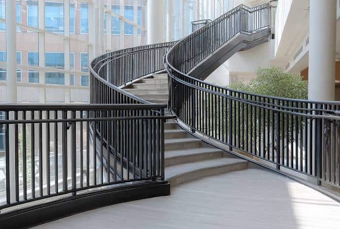 Curved staircase with black handrails