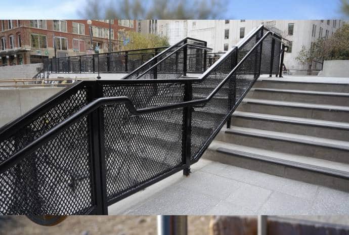 Black metal handrail beside stairs