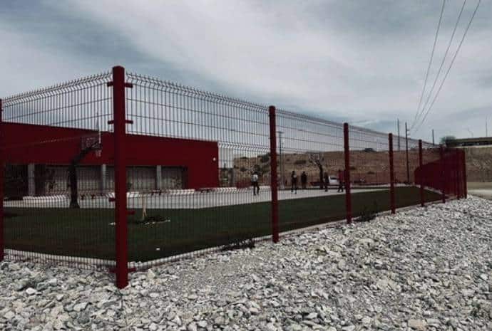 Red fence surrounding a sports area