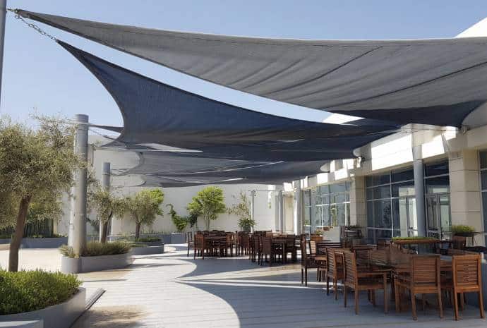 Outdoor dining area with shade sails